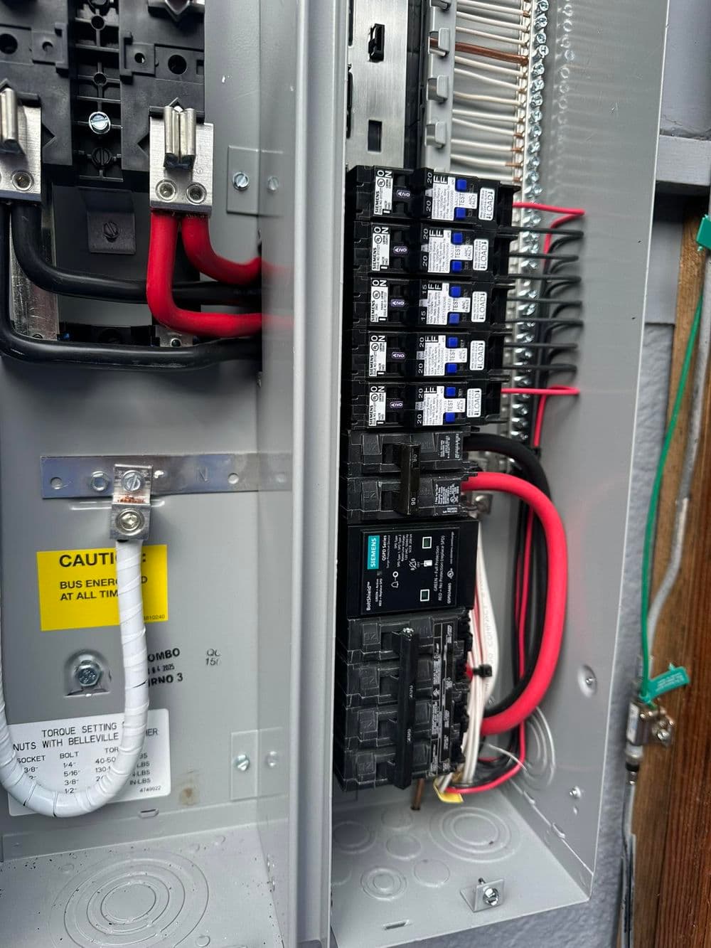 Close-up of an electrical panel showing circuit breakers and wiring connections.
